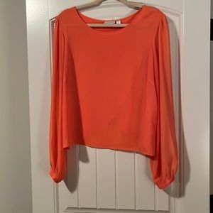 Long sleeve sheer blouse by bisou bisou button at sleeve. Tulip style in back